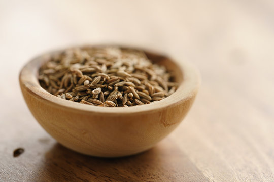 cumin zira seeds in wood bowl on table