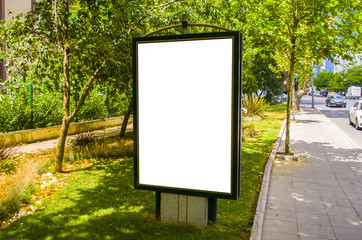 Blank white billboard on the street on a sunny day