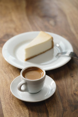 fresh espresso and cheesecake on table