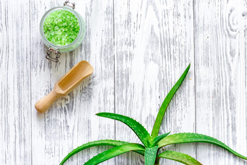 Fresh aloe vera leafs and spa salt on wooden background top view copyspace