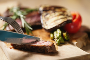 cutting piece from rib eye steak