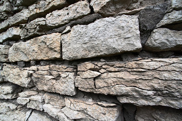 The stones of the old damaged wall are close