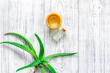 Skin care. Aloe vera gel and aloe vera leafs on wooden background top view copyspace