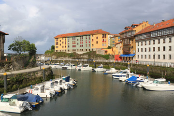 Llanes with boats in the port and some buildings