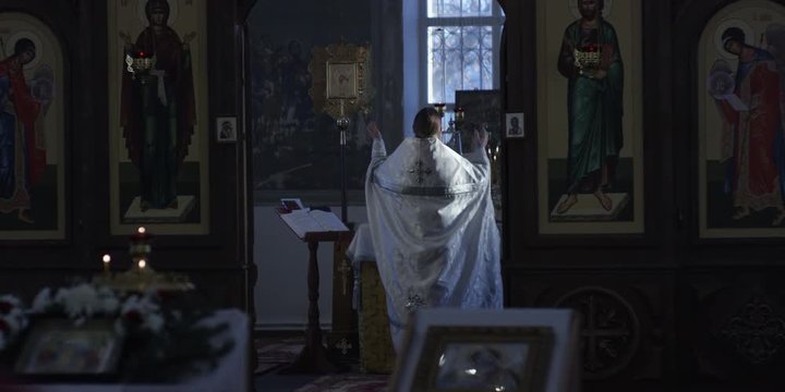 Orthodox priest reads prayer together with christians in Russian Church