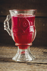 Red juice in a transparent glass with a handle