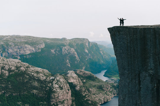 Girls standing on the edge of Preykestalen, Norway
