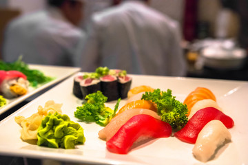chefs preparing sushi