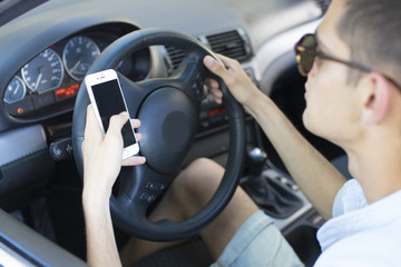 man driving looking at mobile phone