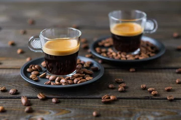 Fotobehang Twee kopjes espresso en koffiebonen op een houten tafel © Pavel Korotkov