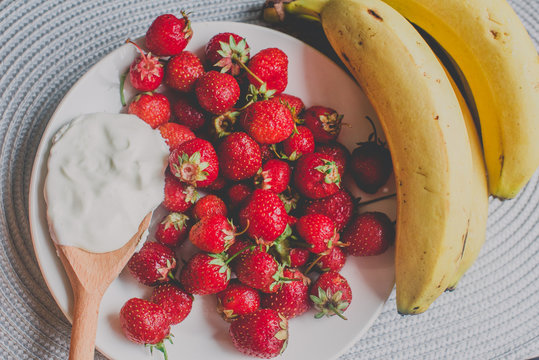 Bunch of bananas and strawberries. Photo toned style Instagram filters. Concept of healthy breakfast