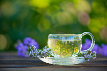 Crystal cup with green tea on table