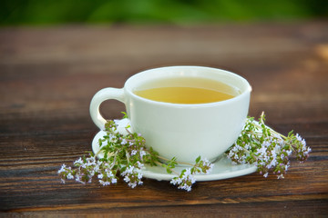 porcelainl cup with green tea on table