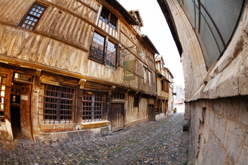 Narrow cobblestone paved street with old houses