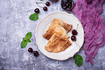 Pancakes with cherry jam and berries