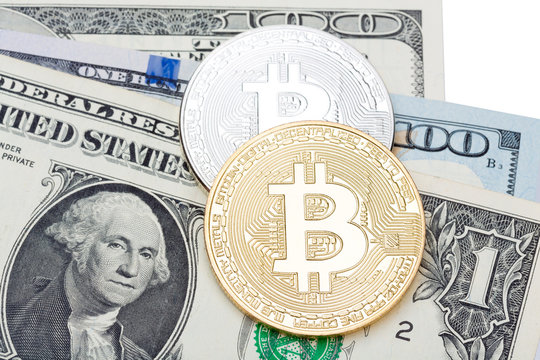 American dollars on white background covered with silver and golden bitcoin.