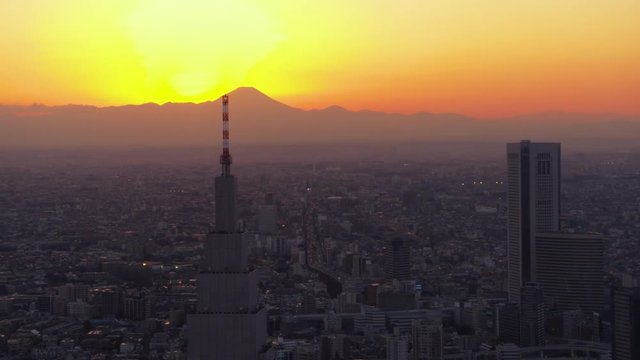 Japan Tokyo Aerial v14 Flying around clock tower with cityscape views sunset Mount Fuji