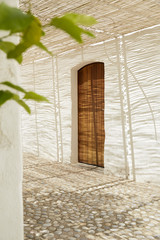 Wood door in a typical mediterranean house in stone floor street