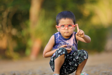 Indian child On eyeglass showing hand direction