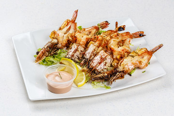 Grilled tiger prawns served with leafs and lemon