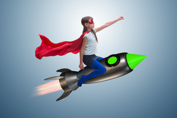 Obraz na płótnie Canvas Little girl flying rocket in superhero concept