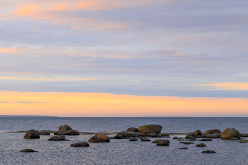 Fototapeta na wymiar Sunset at stoney seashore