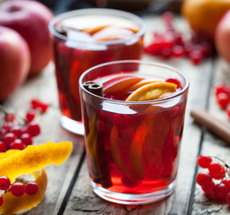 Homemade refreshing cold sangria lemonade or aperol with orange, berries, cinnamon, anise on wooden table. Close up summer vitamin antioxidant beverage.