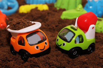 The toy car on the sand.