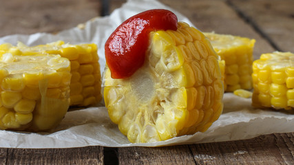 Boiled corn cut into rings with tomato sauce - appetizer (salad)