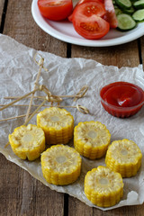 Boiled corn cut into rings with tomato sauce - appetizer (salad)