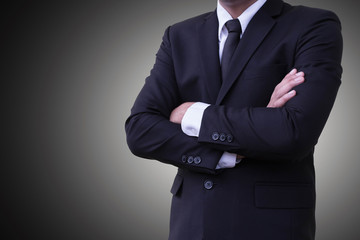 Obraz na płótnie Canvas Business personality standing arms crossed Wear a suit On a gray background or backdrop