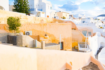 Oia town on Santorini island, Greece. Traditional and famous white and rose  houses at sunny day