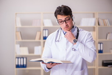 Young man doctor in medical concept