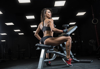 Fototapeta na wymiar attractive young woman working out with dumbbells - bikini fitness girl