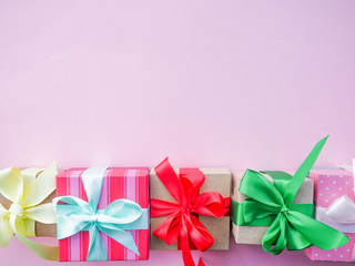 gift box with colorful satin ribbon, pink background, greetings on women's day, Mother's Day, Valentine's Day, Birthday, Christmas, space for text