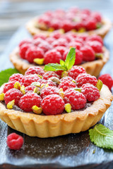 Baskets of pastry with chocolate and raspberries.