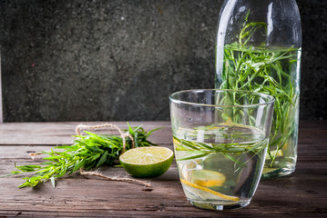 Summer refreshment diet drinks. Infused detox waters in different glasses nd bottles with rosemary,...