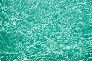 Background of clean water in a blue swimming pool