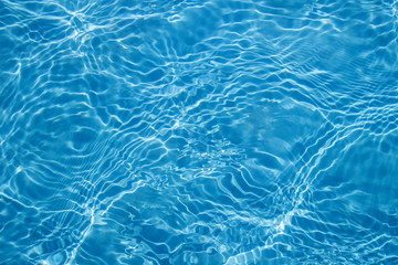 Fototapeta na wymiar Background of clean water in a blue swimming pool