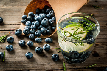Summer refreshment diet drinks. Infused detox waters in different glasses nd bottles with rosemary,...