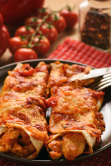 Enchiladas - mexican food, tortilla with chicken, cheese and tomatoes.