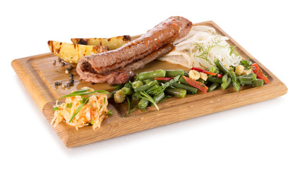 meat with vegetables on a wooden board