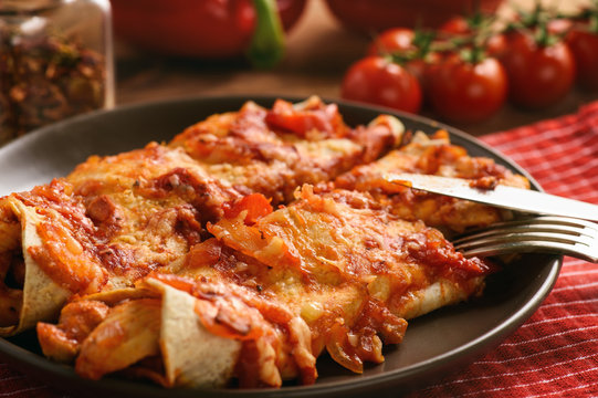 Enchiladas - mexican food, tortilla with chicken, cheese and tomatoes.