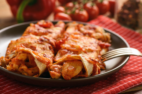 Enchiladas - mexican food, tortilla with chicken, cheese and tomatoes.