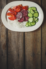 Background of vegetables and sausages (salami) on wooden boards