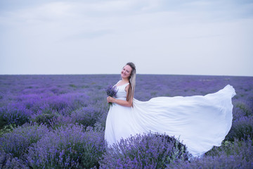 Young girl in white dress in lavender field