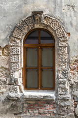 Old window on ancient wall