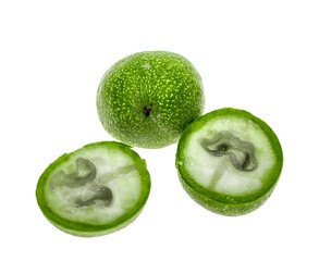 Green walnut fruit on a white background