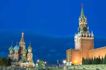 Fototapeta premium Blue hour sunset view of St. Basil Cathedral and Kremlin tower at Moscow Red Square. World famous Russian Moscow landmarks. Tourism and travel concept