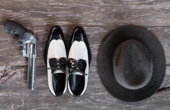 ganster men's shoes and a revolver